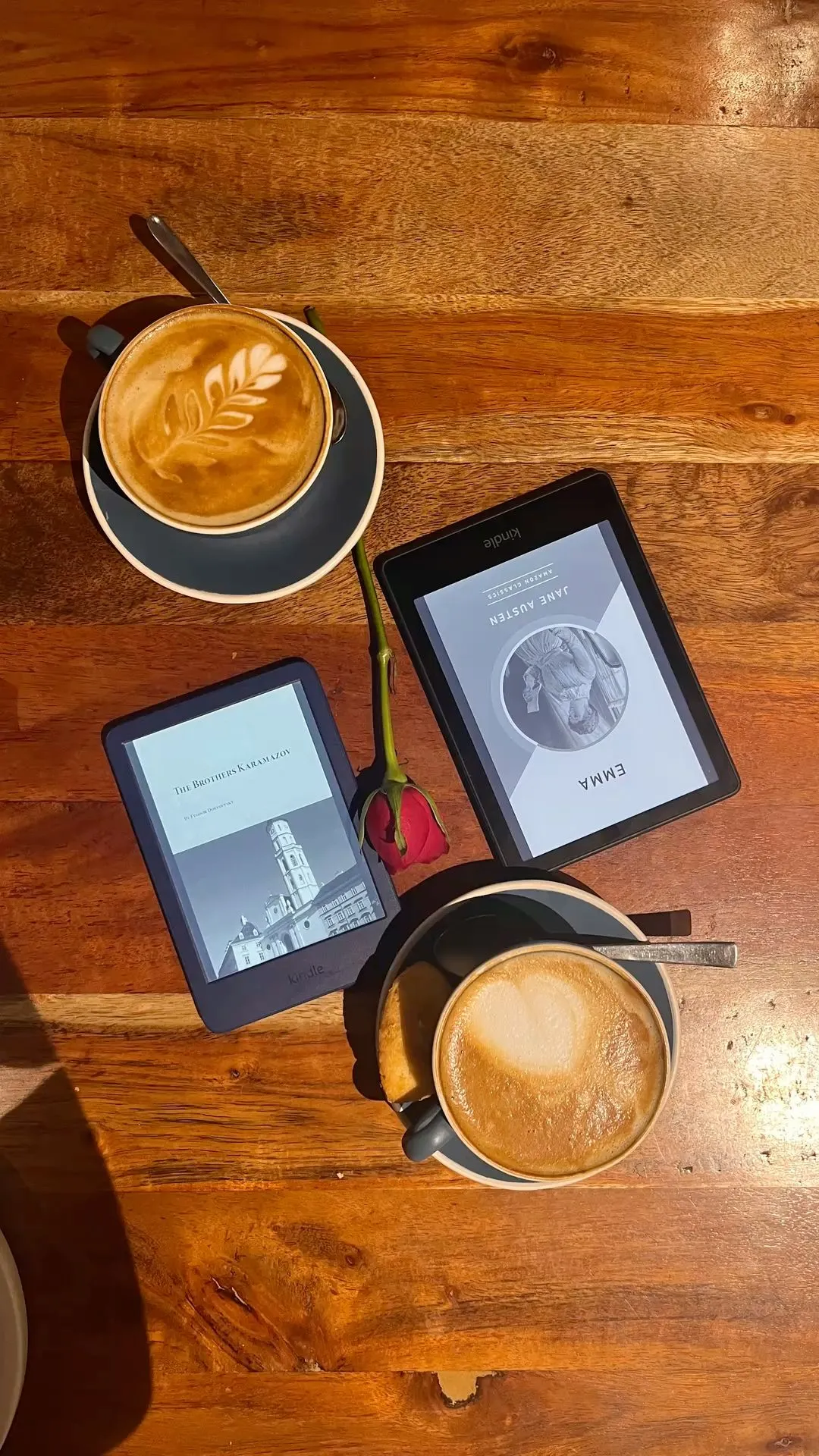 two cups of coffee and an ipad on a wooden table