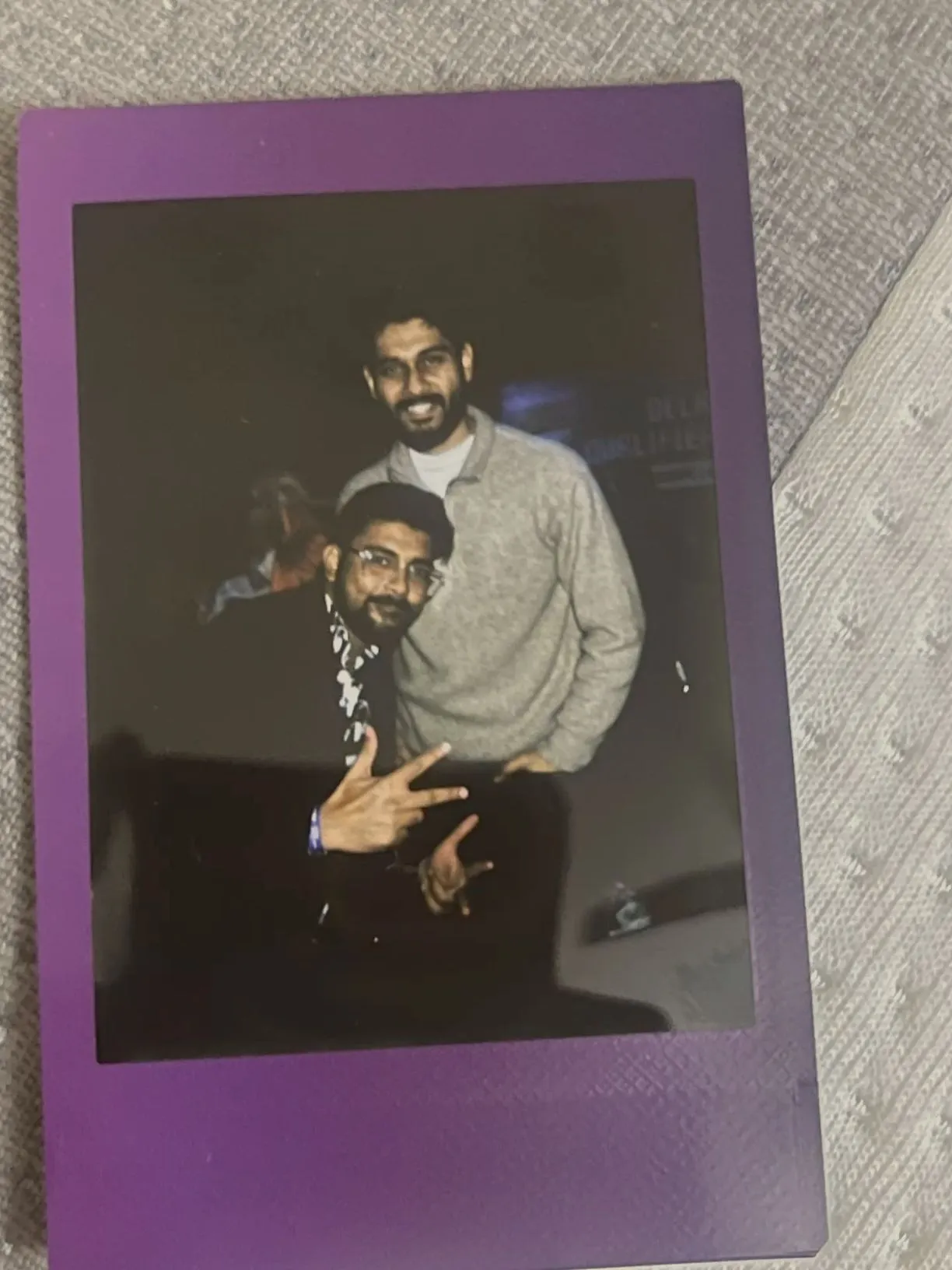 an old photo of two men with one pointing at the camera