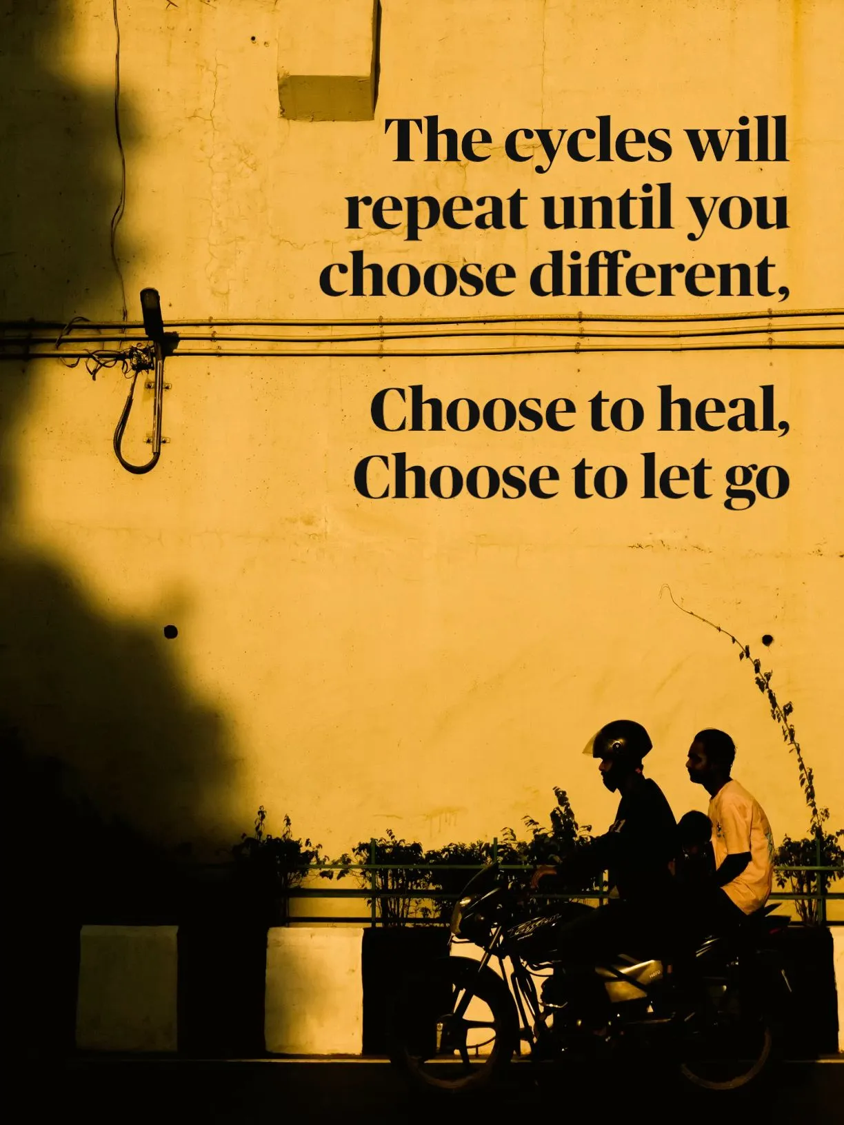 two people sitting on a motorcycle in front of a yellow wall with a quote from the book choose to heal, choose to let go